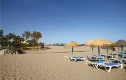 Rustig zandstrand in Mijas met ligstoelen, parasols en uitzicht op de Middellandse Zee